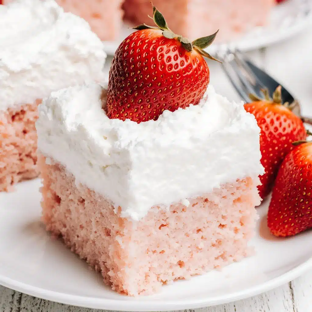 Melt in your mouth strawberry cloud cake topped with fresh strawberries and cream