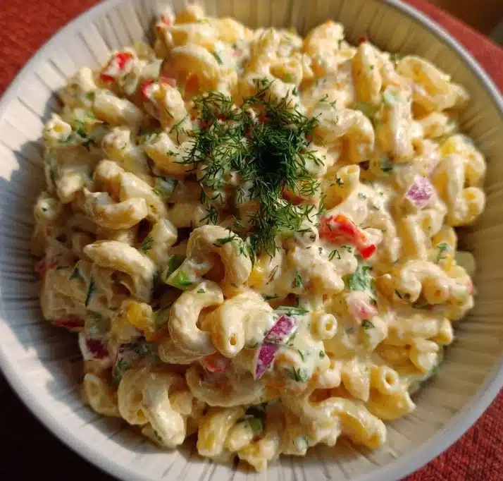 Bowl of classic macaroni salad with vegetables and dressing
