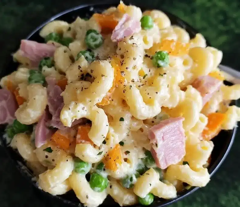 A bowl of Ham and Cheese Macaroni Salad with fresh ingredients
