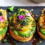 Delicious hash brown avocado toast topped with fresh herbs and spices